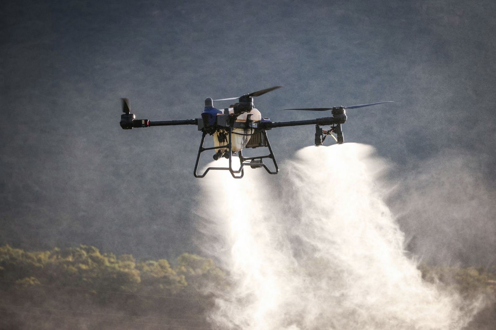 Agricultural drone spraying a field