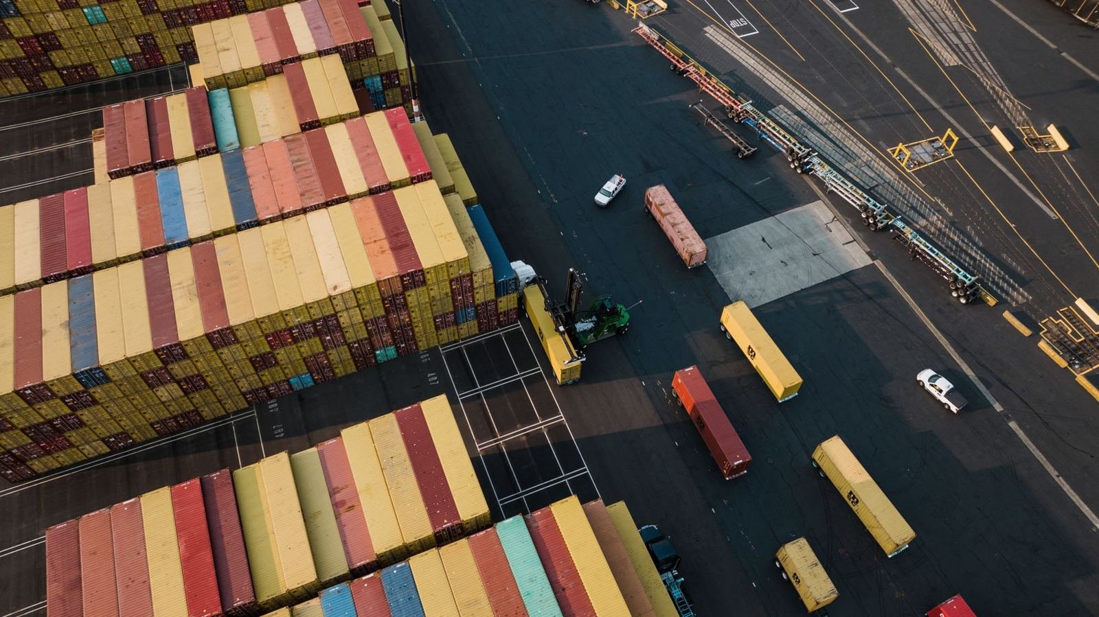 Containers and trucks in a port yard, from above